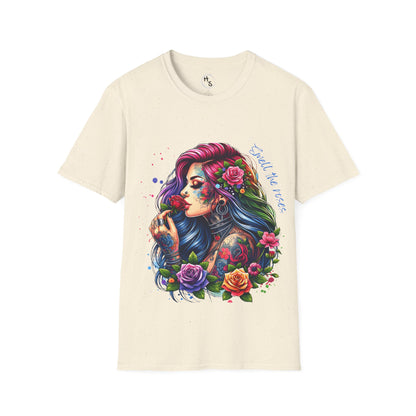 Beige t-shirt with a colorful graphic of a woman with tattoos and flowers on a white background