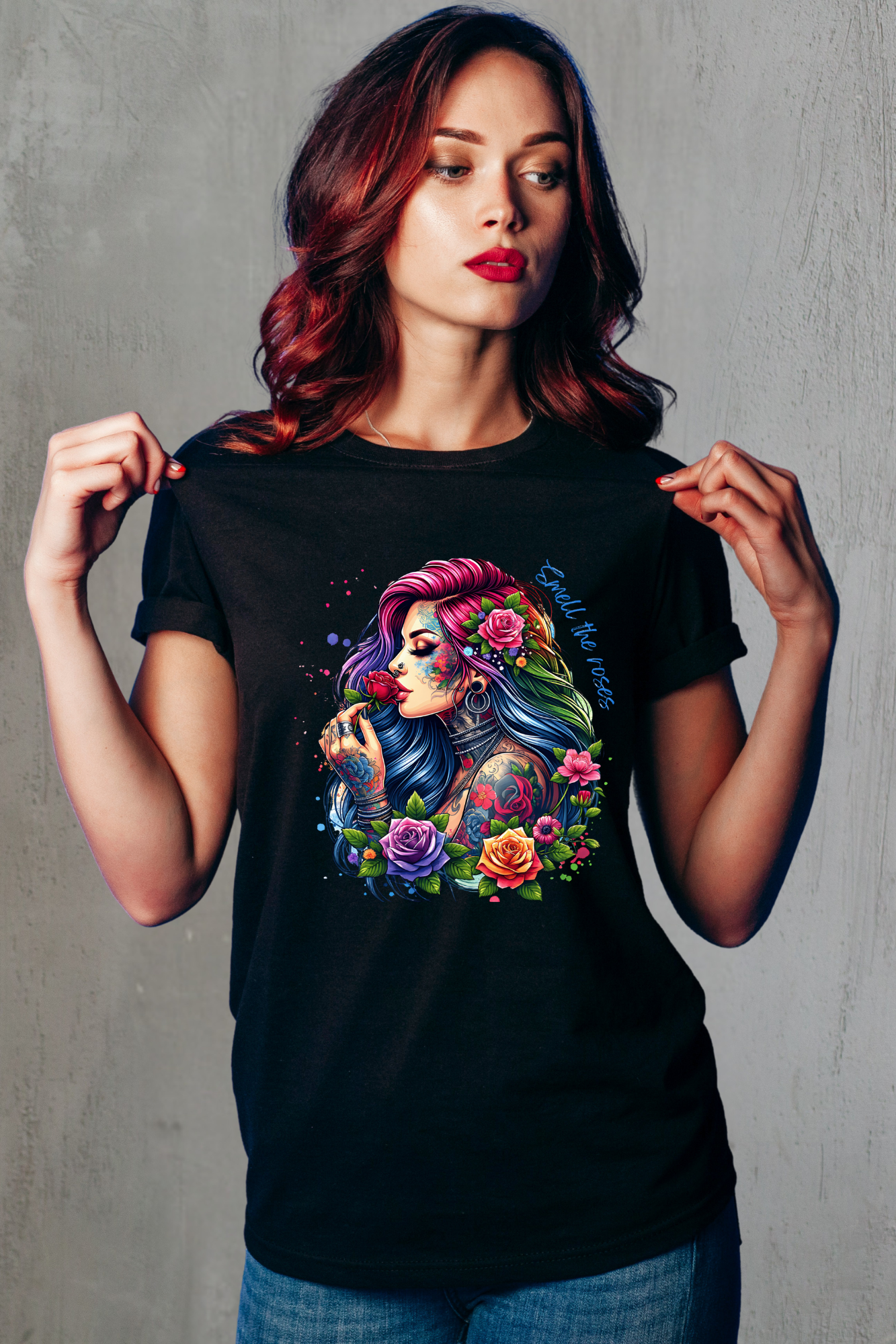 Woman wearing a black t-shirt with a colorful graphic design of a woman with tattoos and flowers.