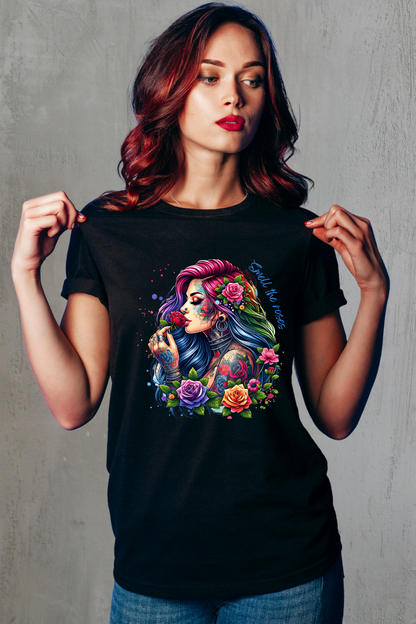 Woman wearing a black t-shirt with a colorful graphic design of a woman with tattoos and flowers.