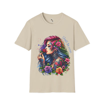 Beige t-shirt with a colorful graphic of a woman with flowers in her hair on a white background