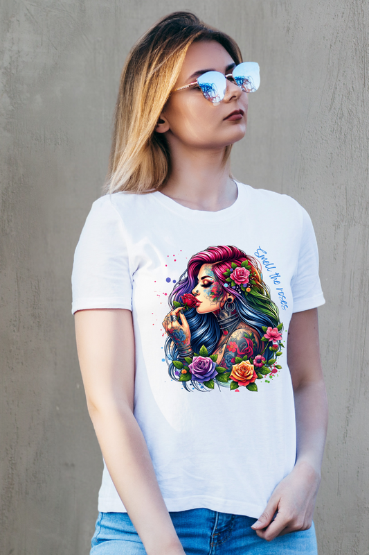 Woman wearing a white t-shirt with a colorful graphic design against a plain background
