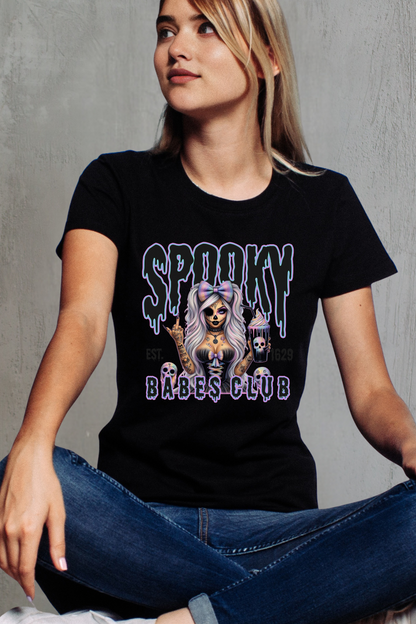 Person wearing a black t-shirt with 'Spooky Babes Club' graphic design.