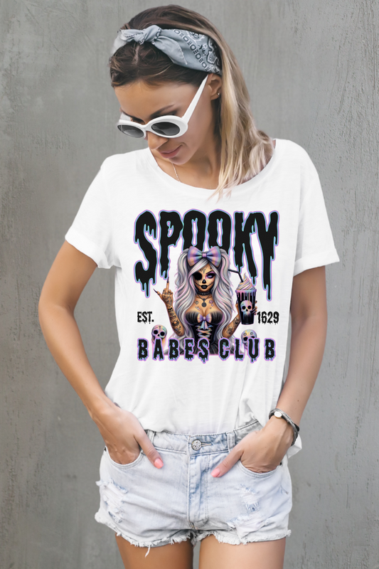 Woman wearing a white t-shirt with 'Spooky Babes Club' design against a white background