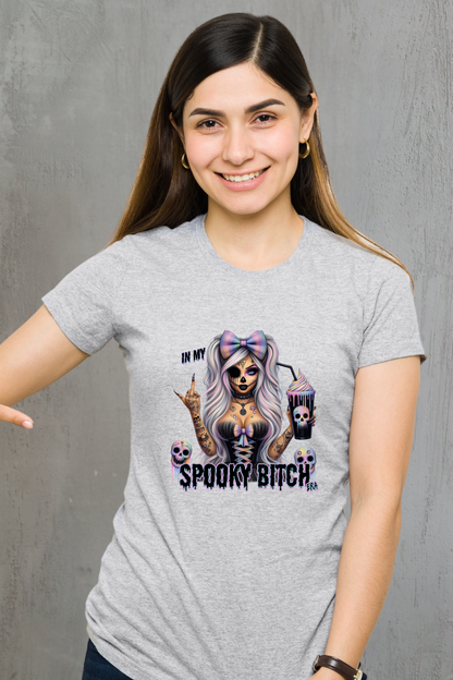 Woman wearing a gray t-shirt with a graphic design and text.