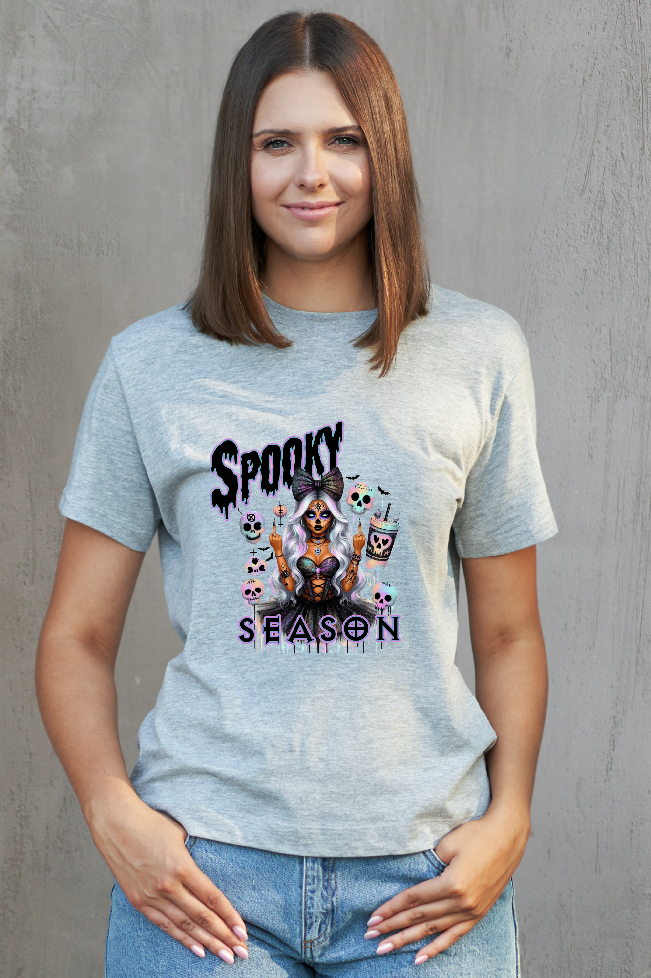 Woman wearing a grey t-shirt with a graphic design and text against a grey background