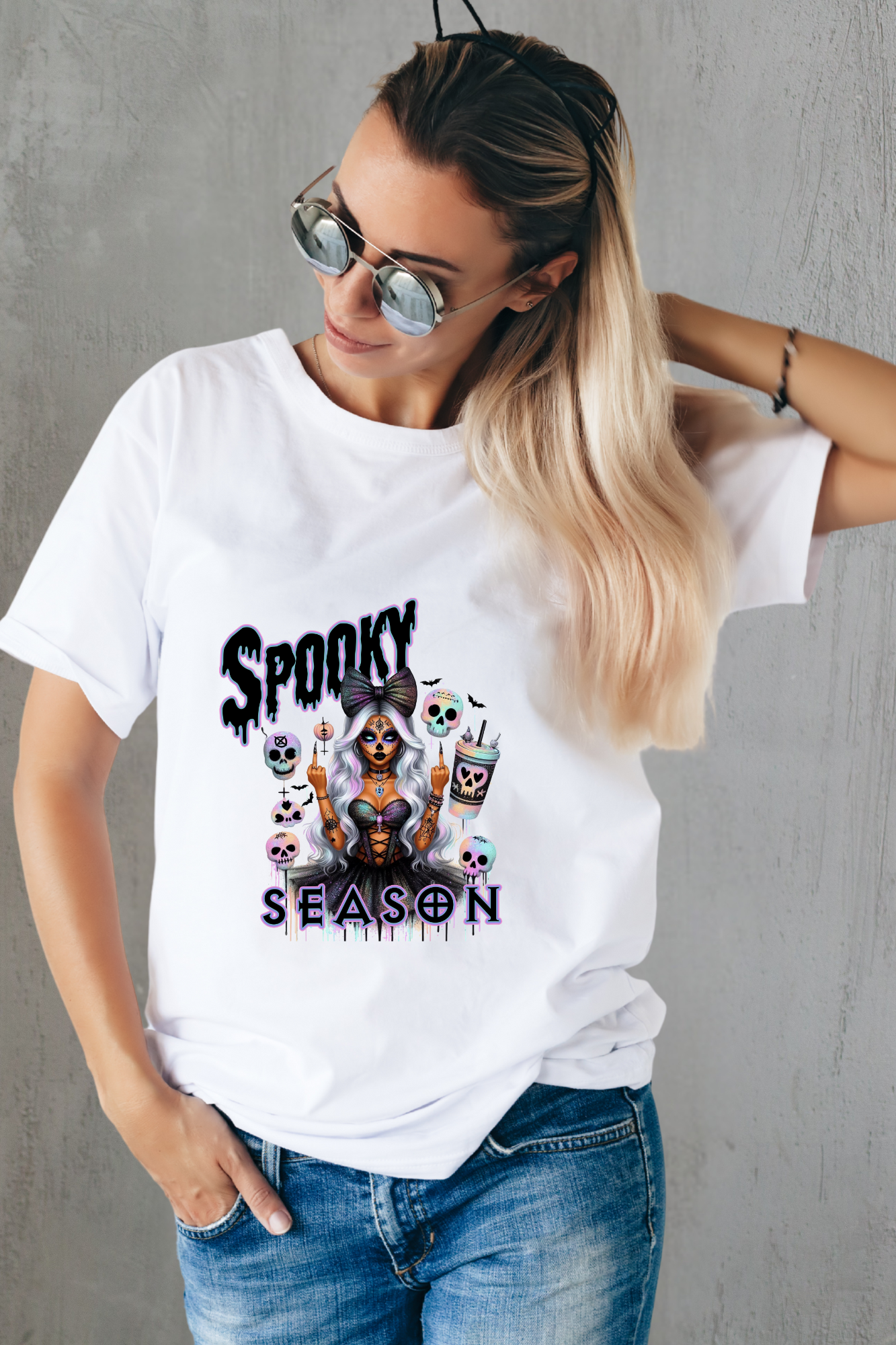 Person wearing a white t-shirt with 'Spooky Season' graphic design.