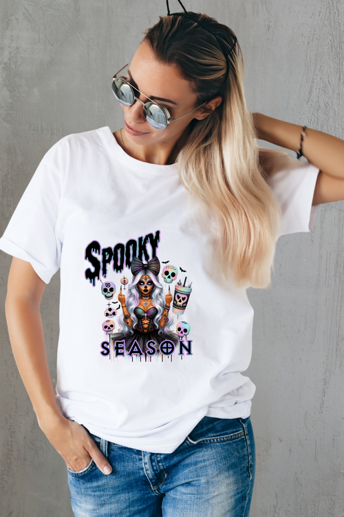 Person wearing a white t-shirt with 'Spooky Season' graphic design.