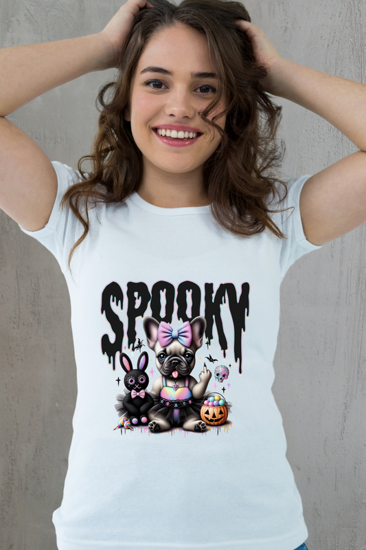 Woman wearing a white t-shirt with cartoon dogs and 'Spooky' text on a plain background