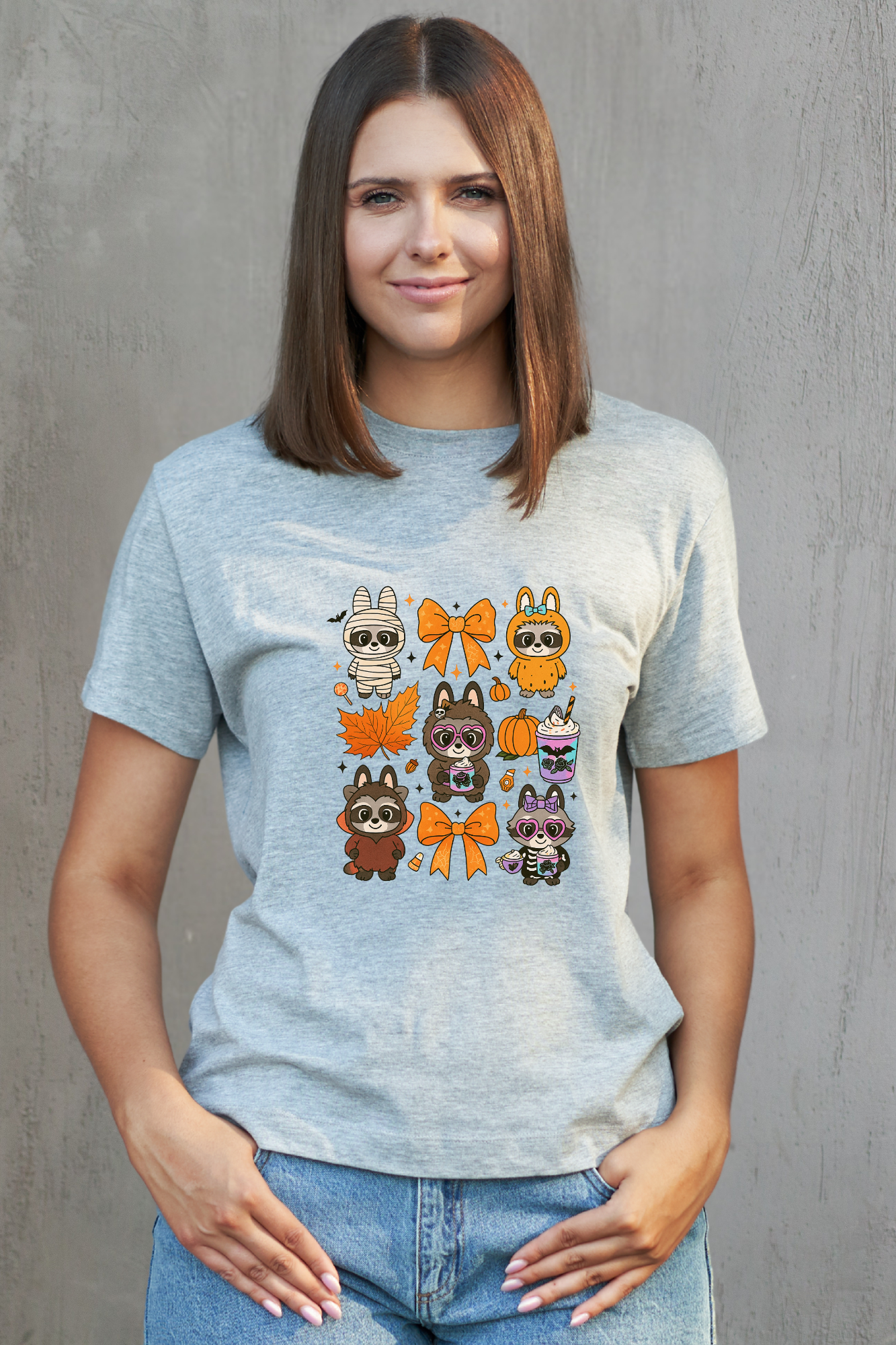 Woman wearing a grey t-shirt with cartoon character designs on a gray background