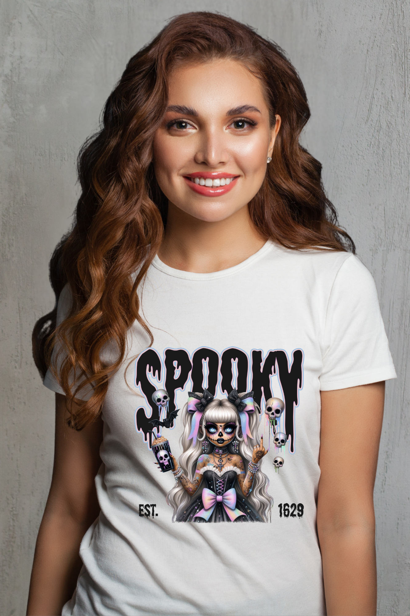 Woman wearing a white t-shirt with a Halloween-themed design and text.
