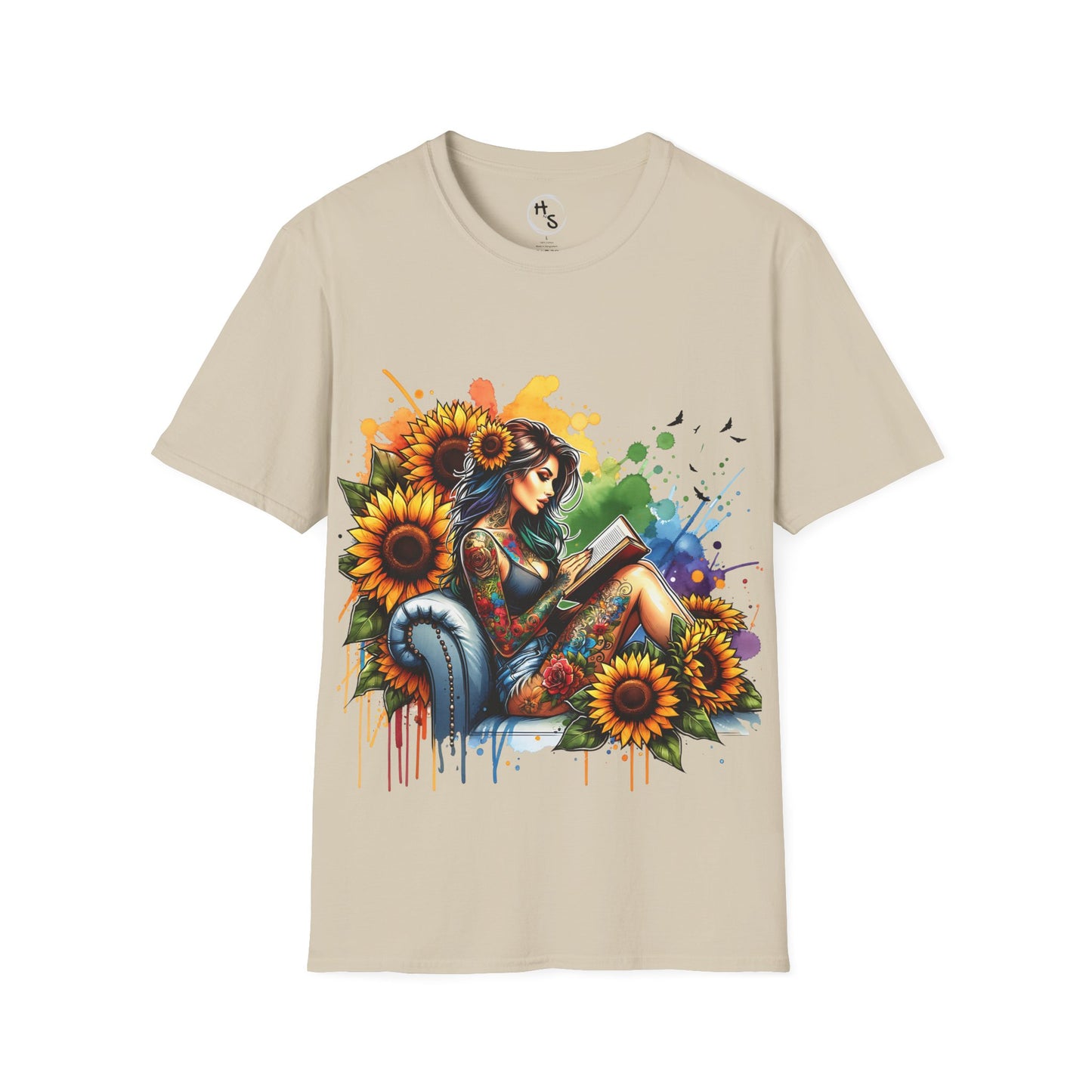 Beige t-shirt with a colorful graphic of a woman reading a book surrounded by flowers on a beige background.