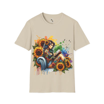 Beige t-shirt with a colorful graphic of a woman reading a book surrounded by flowers on a beige background.