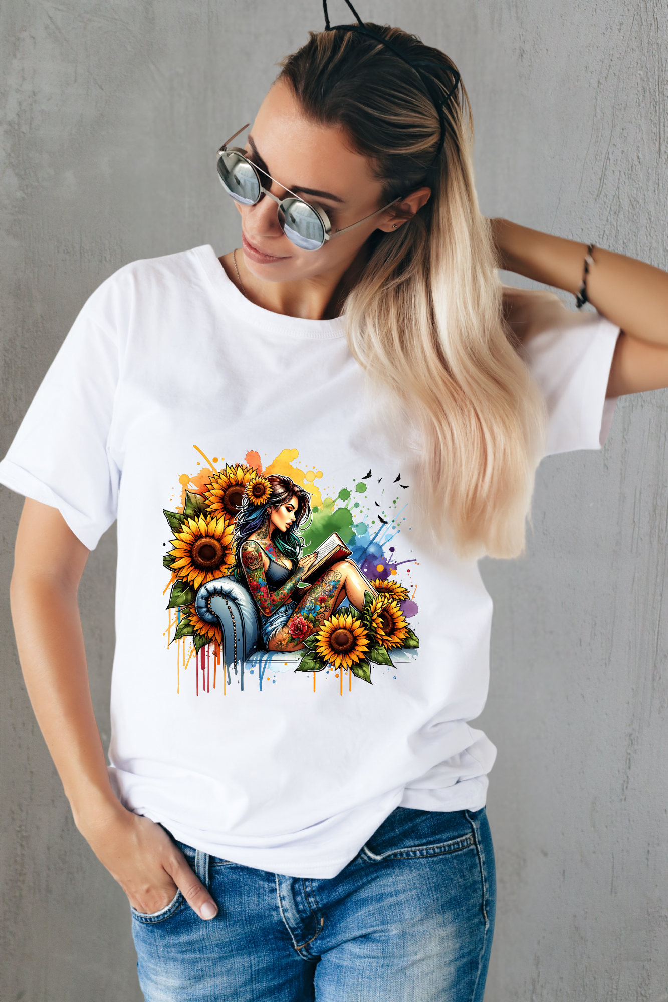 Woman wearing a white t-shirt with a colorful graphic design against a white wall.