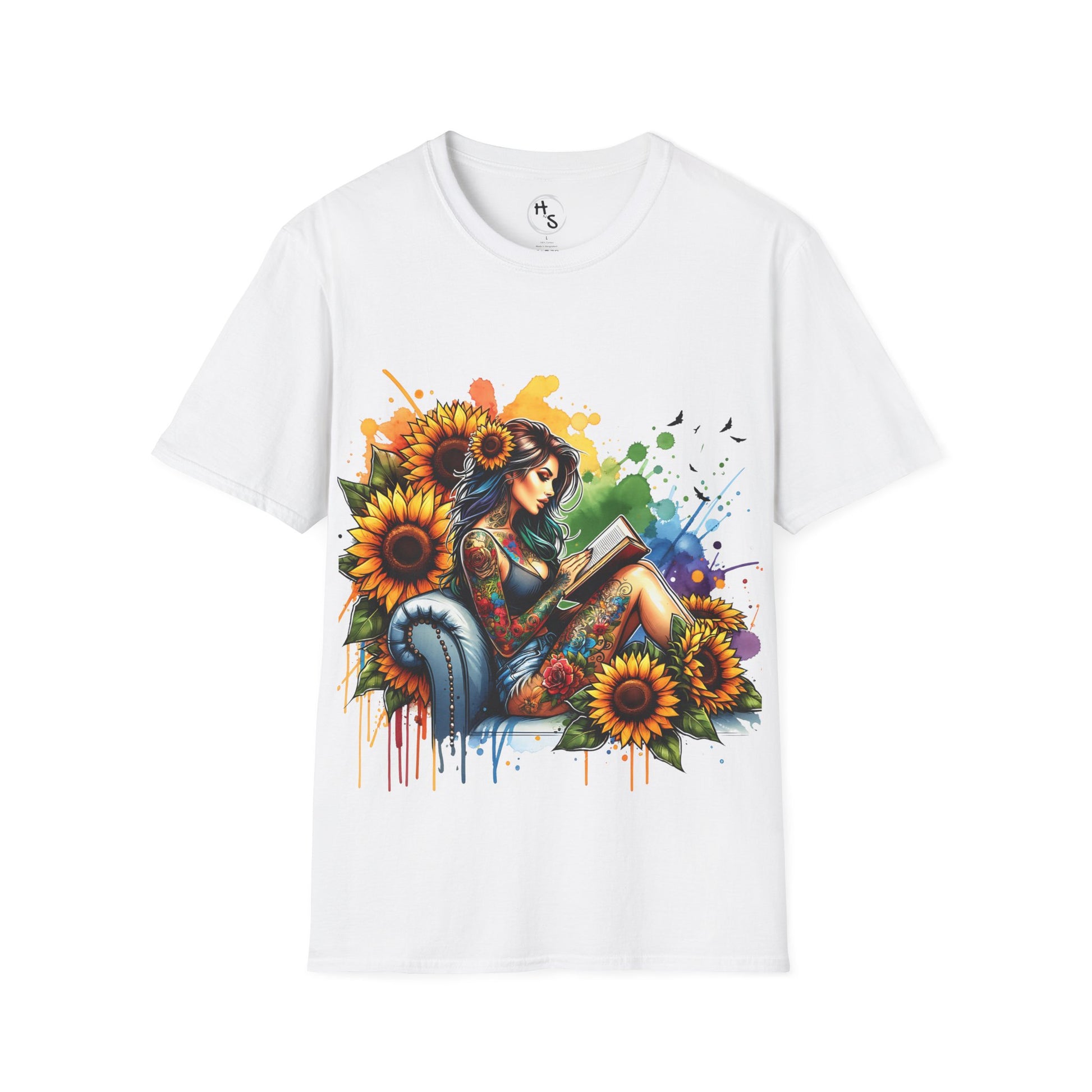White t-shirt with a colorful design of a woman reading a book surrounded by sunflowers on a white background.
