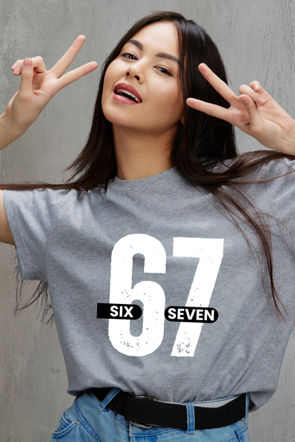 Woman wearing a gray t-shirt with '67 Six Seven' design, making peace signs.