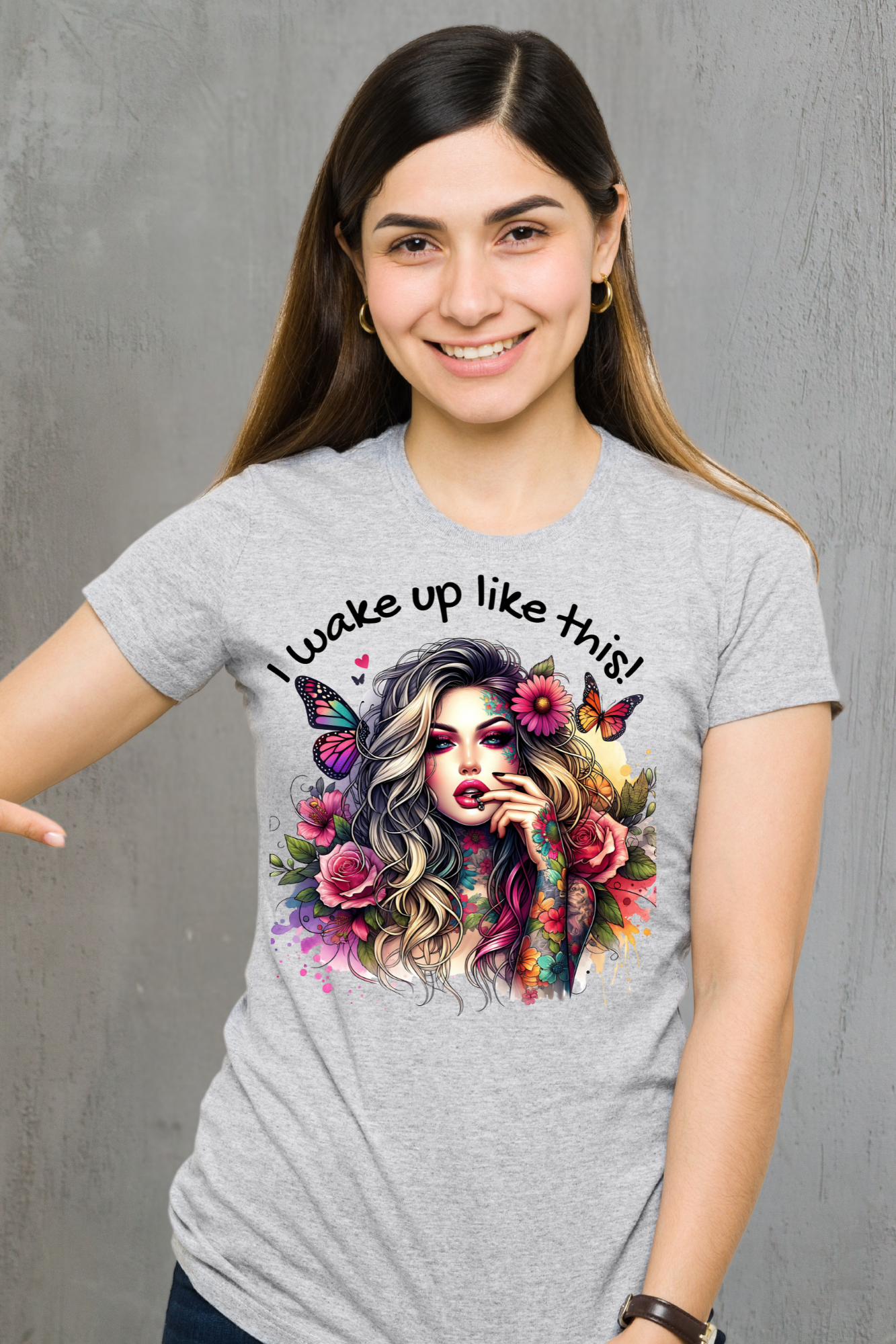 Woman wearing a gray t-shirt with a colorful graphic and text against a gray background