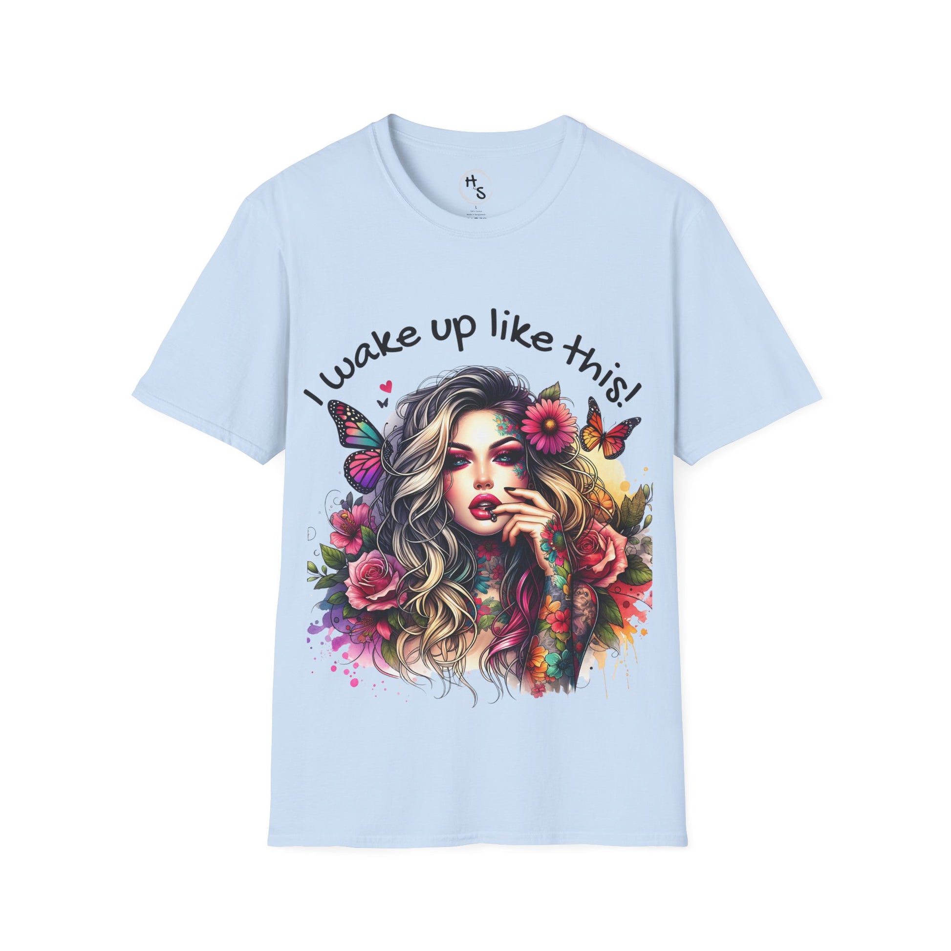 Light blue t-shirt with a colorful graphic of a woman with flowers and butterflies and text 'I wake up like this!' on a white background.