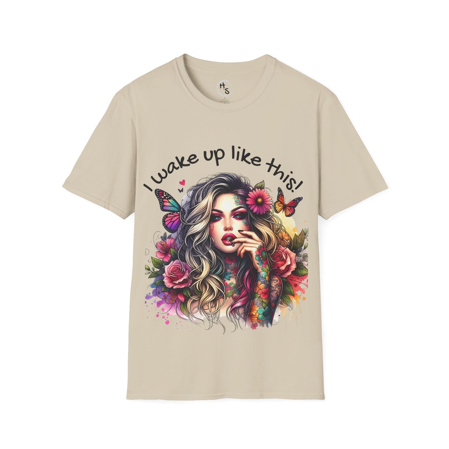 Beige t-shirt with a colorful graphic of a woman with flowers and butterflies and text 'I wake up like this!'.