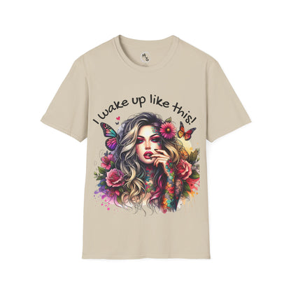 Beige t-shirt with a colorful graphic of a woman with flowers and butterflies and text 'I wake up like this!'.