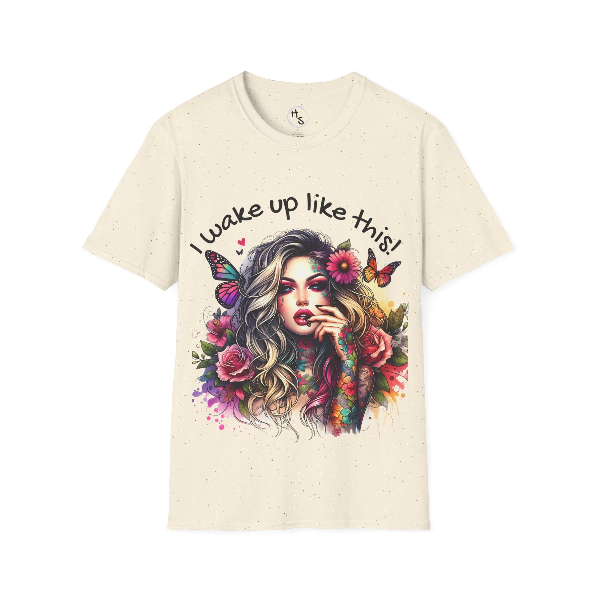 Beige t-shirt with a colorful design of a woman with flowers and butterflies, and text 'I wake up like this!'.